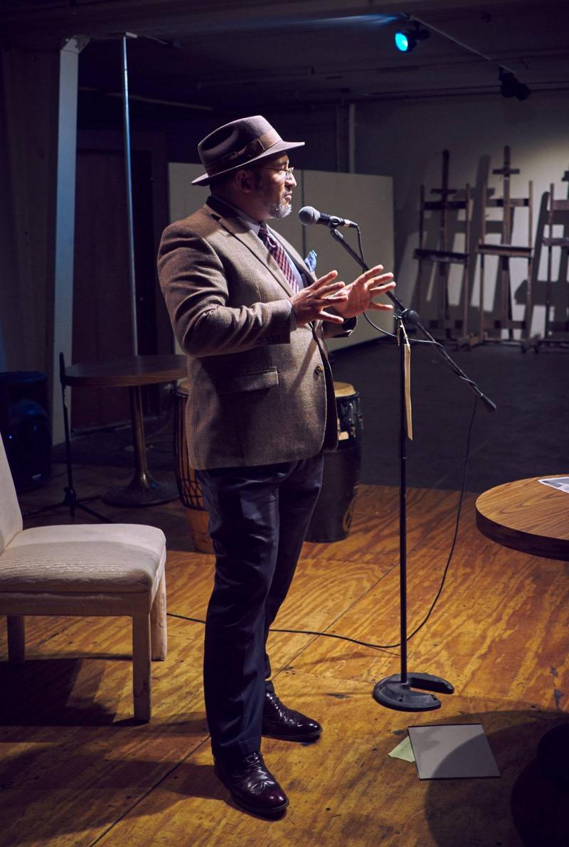Raymundo Eli Rojas MCing a poetry reading in El Paso, Texas